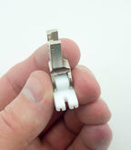Close-up of T35 invisible zipper foot on a sewing machine