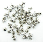 Crystal stone studs showcased on denim fabric.