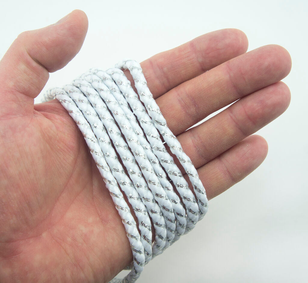 Close-up of white nylon and metallic silver trim for decoration.