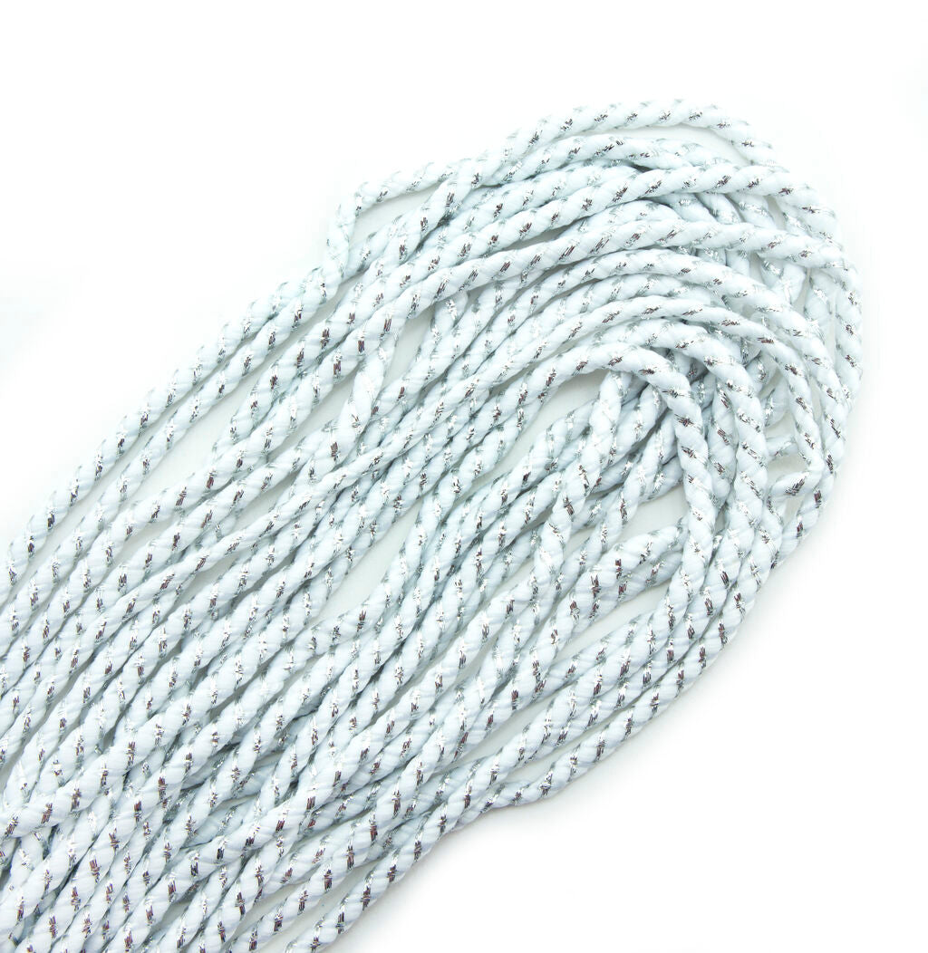 White nylon and metallic silver trim on a roll, 6 mm wide.