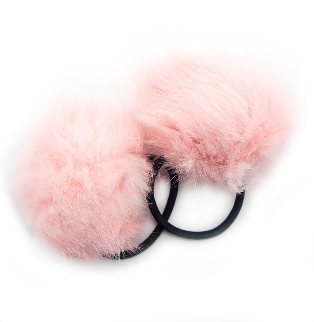 Two baby pink pom pom hair bands displayed on a white background.