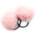 Two baby pink pom pom hair bands displayed on a white background.
