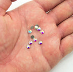 Close-up of premium A+ glass diamante rhinestones in various lighting.