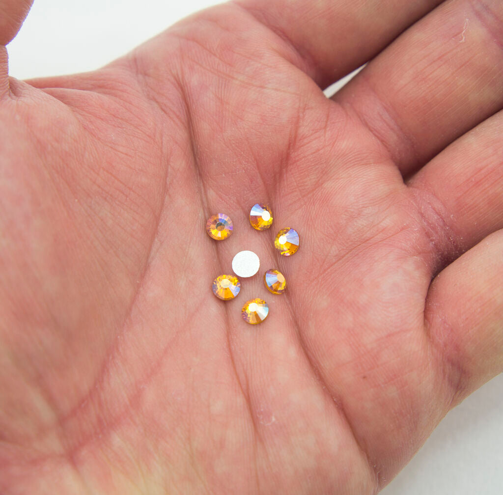 Close-up of 5 mm AB amber iron-on rhinestones in a pack.