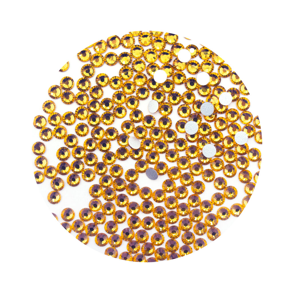 Pack of amber glass diamante rhinestones for garment decoration.