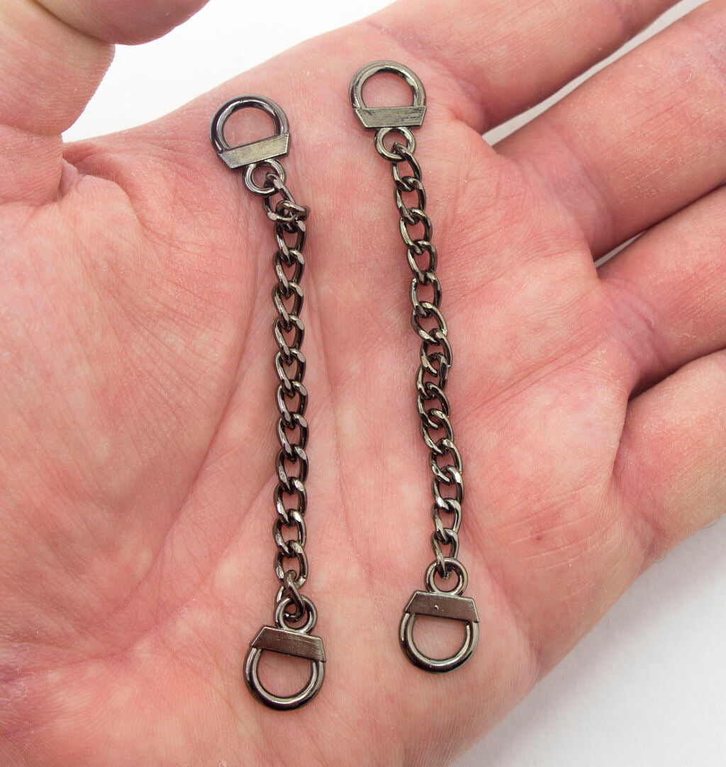 Both gold tone and dark metal sew on coat hangers side by side