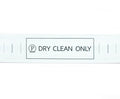 Roll of 2000 'DRY CLEAN ONLY' wash care labels on a table.