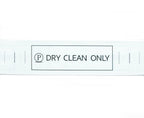 Roll of 2000 'DRY CLEAN ONLY' wash care labels on a table.