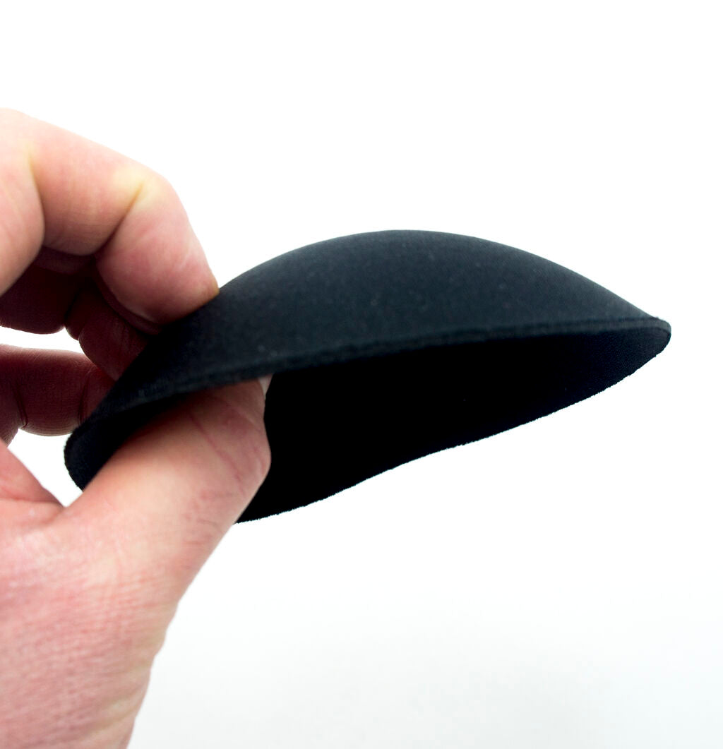 Close-up of soft black round bra pads, perfect for comfortable support.