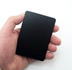 Close-up of a glossy mini black message board with liquid chalk writing.