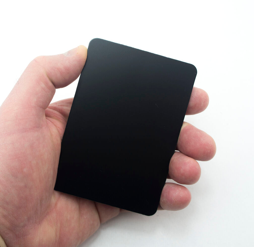 Close-up of a glossy mini black message board with liquid chalk writing.