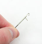 Close-up of the loop turner showing its curved tip for easy fabric turning.