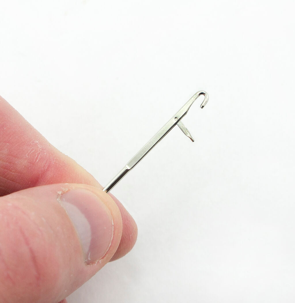 Close-up of the loop turner showing its curved tip for easy fabric turning.