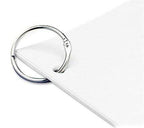 Binding rings in use, holding together sheets of paper and swatches.