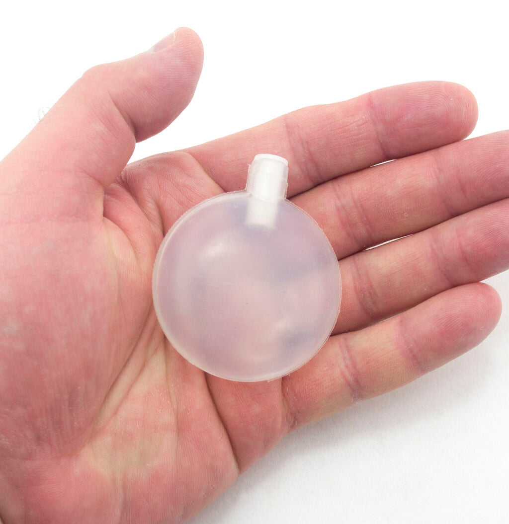 Close-up of a large round toy squeaker for soft toy making.