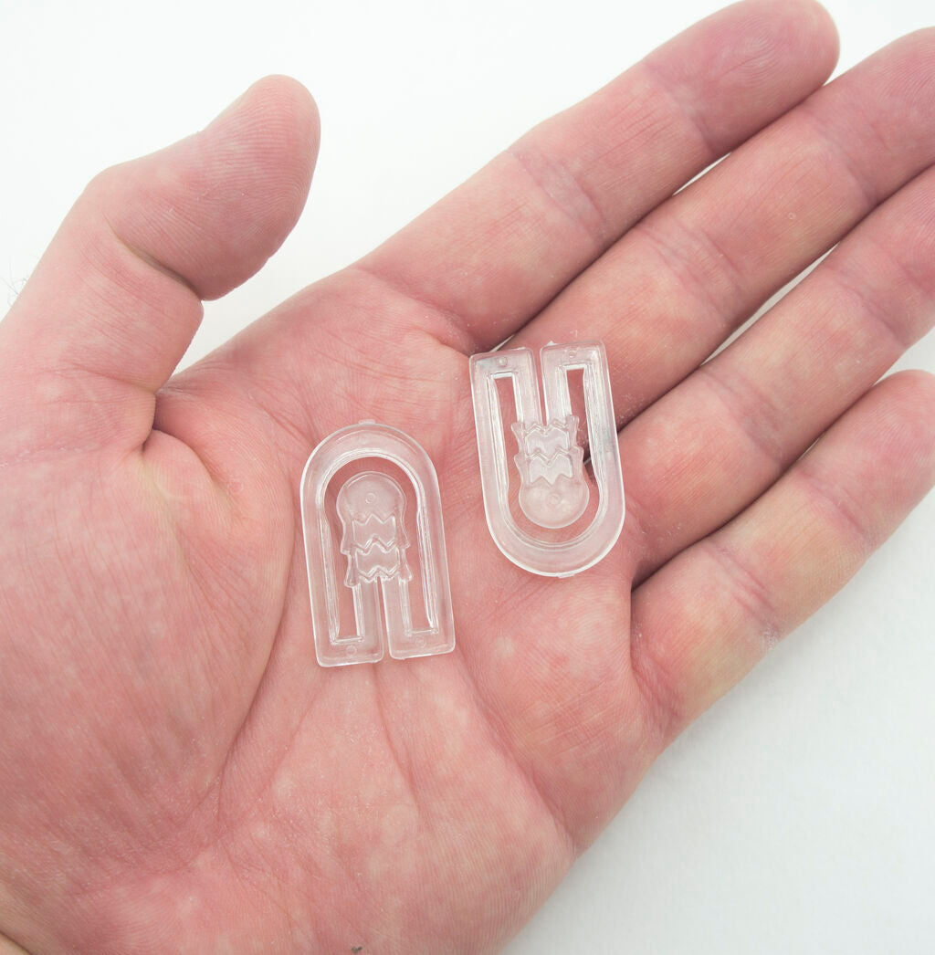 Close-up of a clear plastic U-shape garment shirt clip.