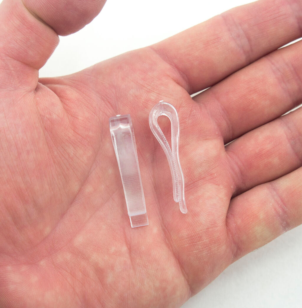 Close-up of clear plastic shirt clips, measuring 38 x 6 mm.