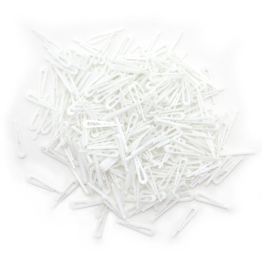 Pack of small white plastic alligator shirt clips for garments.
