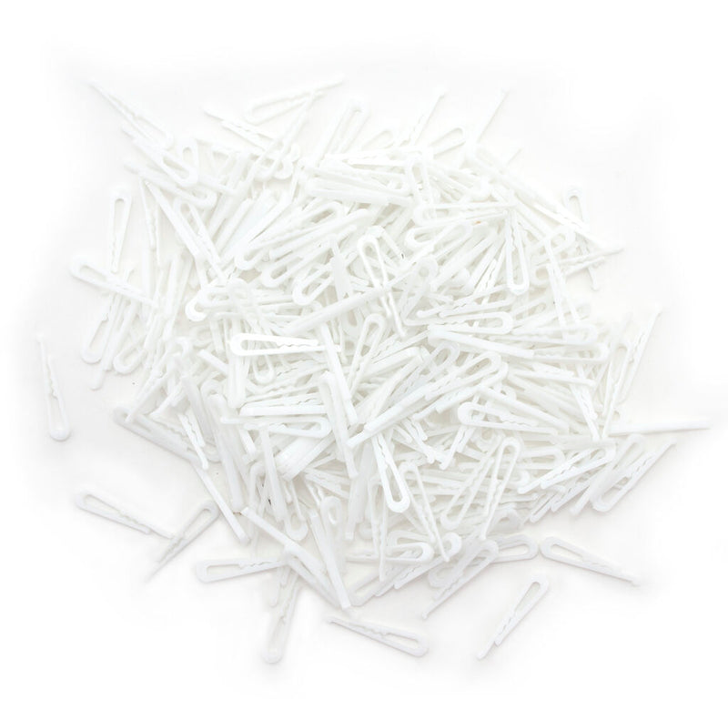 Pack of small white plastic alligator shirt clips for garments.