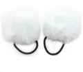 Fluffy white pom pom hair bands displayed on a white background.