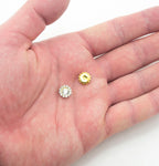 Close-up of a single round glass crystal sew on embellishment, 7.4 mm diameter.