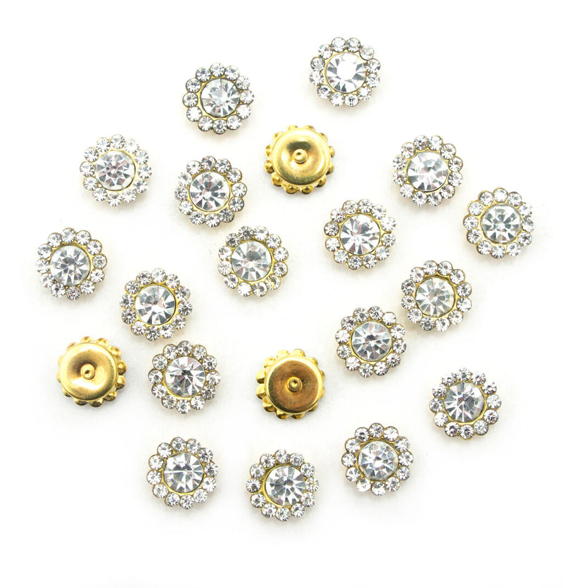 Pack of 20 small round white glass crystal embellishments in gold tone settings.
