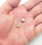 Close-up of a golden champagne glass crystal embellishment for sewing.