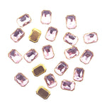 Rectangular light pink crystal glass sew in trim in gold tone setting.
