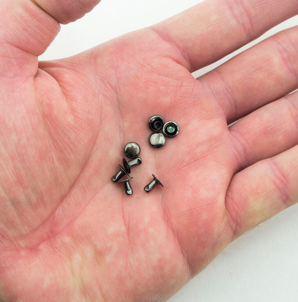 Close-up of 5 mm diameter press studs suitable for jeans and jackets.