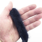 Close-up of navy blue mink fur piping showing its soft texture.