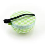 Close-up of the 60mm green check wrist pin cushion with pins.