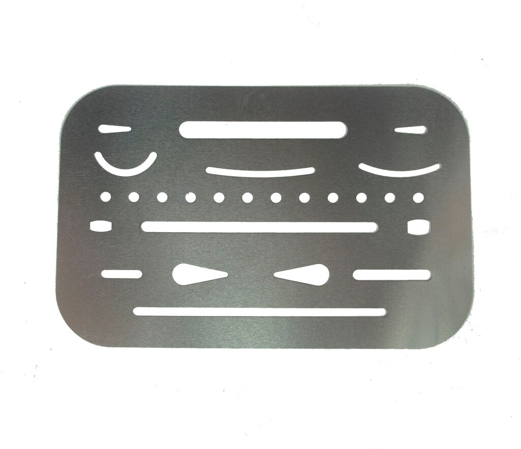 Metal credit card size drawing shapes template stencil on a flat surface.