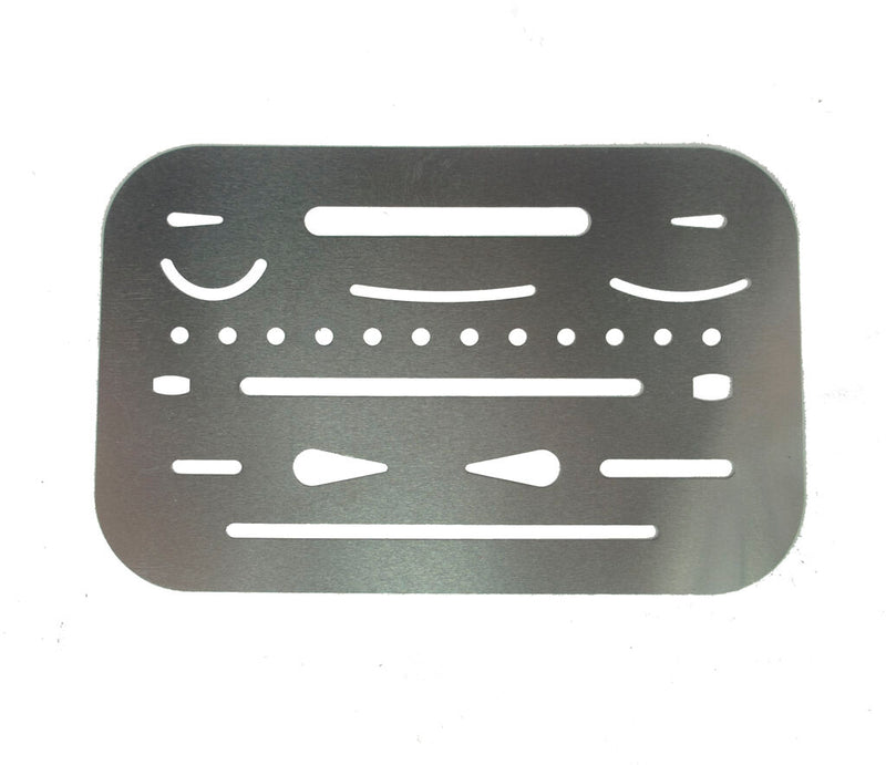 Metal credit card size drawing shapes template stencil on a flat surface.