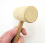 Wooden mallet with a total length of 230mm, placed on a workbench.
