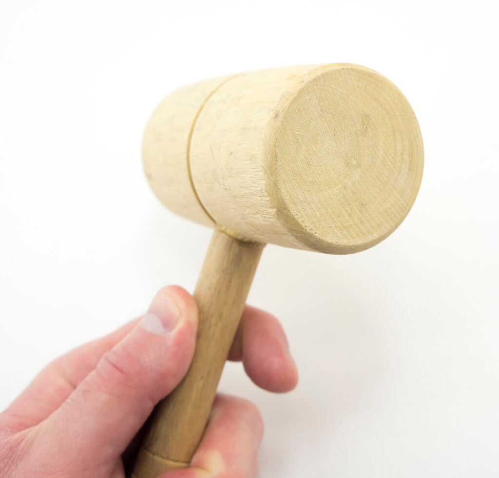 Wooden mallet with a total length of 230mm, placed on a workbench.