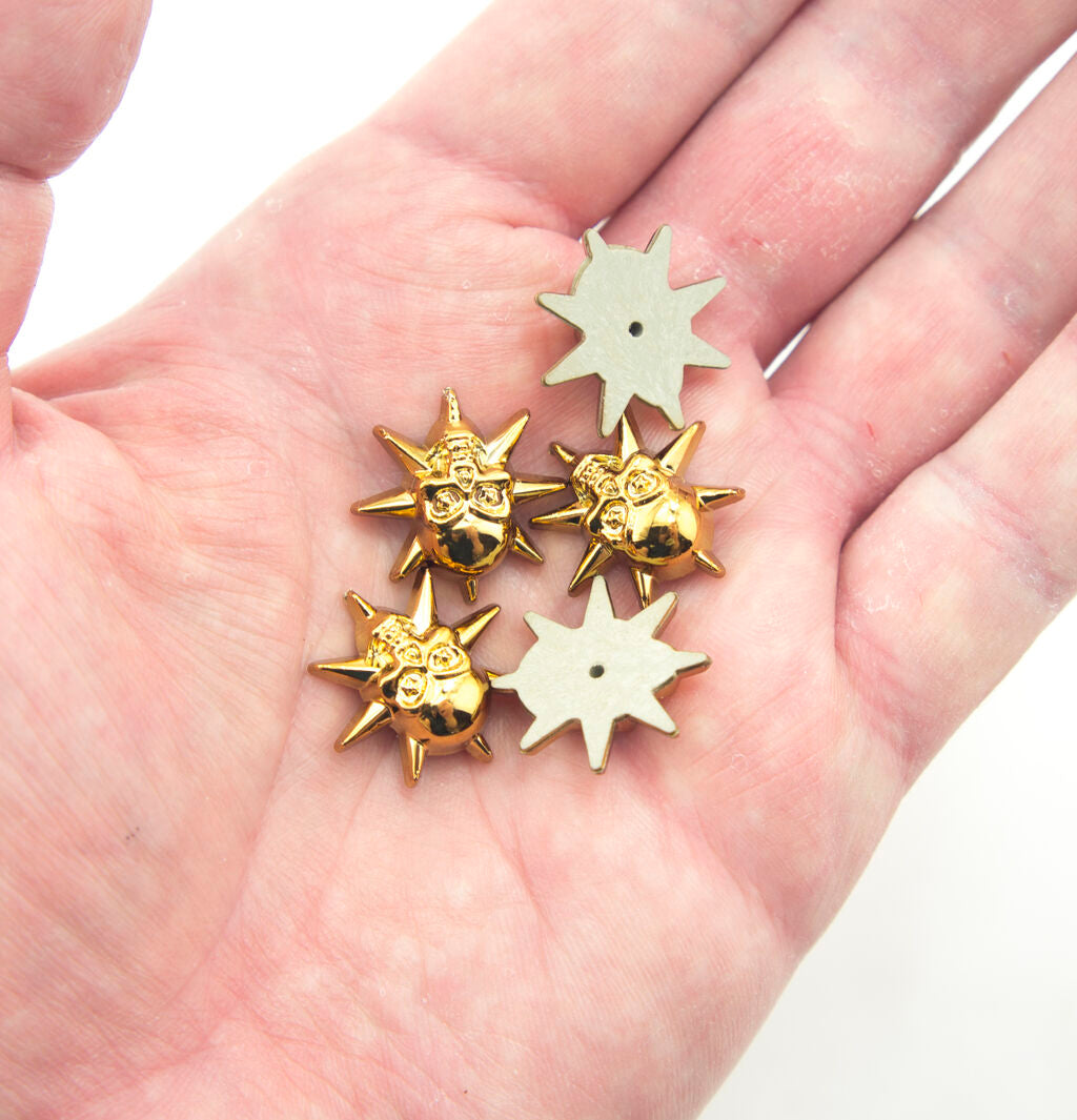 Display of light gold tone skull and star embellishments