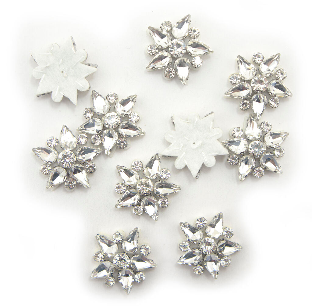 Five-point clear crystal glass star embellishments on white felt backing.