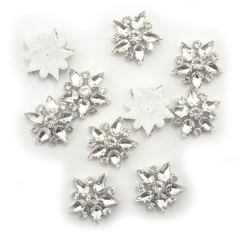 Five-point clear crystal glass star embellishments on white felt backing.