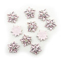Five-point pink crystal glass star embellishments on a white background.