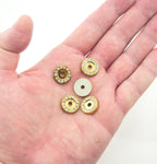 Display of round gold tone embellishments on a fabric