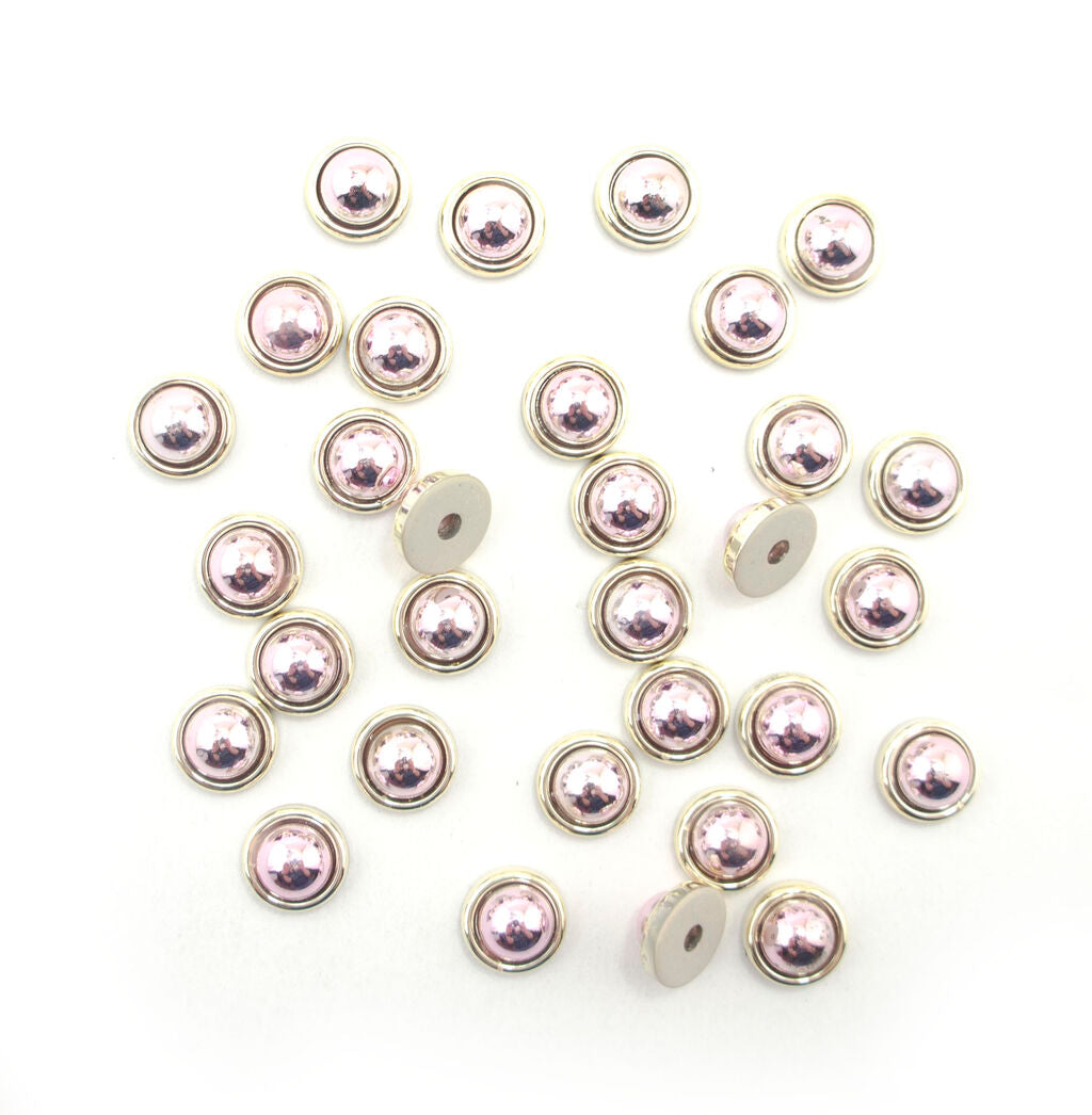 Pack of 30 round rose and gold tone trims, 11mm diameter.