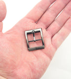 Close-up of a gunmetal square buckle, showing its size and finish.
