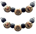 Gold tone and black circular discs pendant chain displayed on a white background.