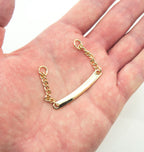 Close-up of a gold tone metal coat hanger showing the chain loop.