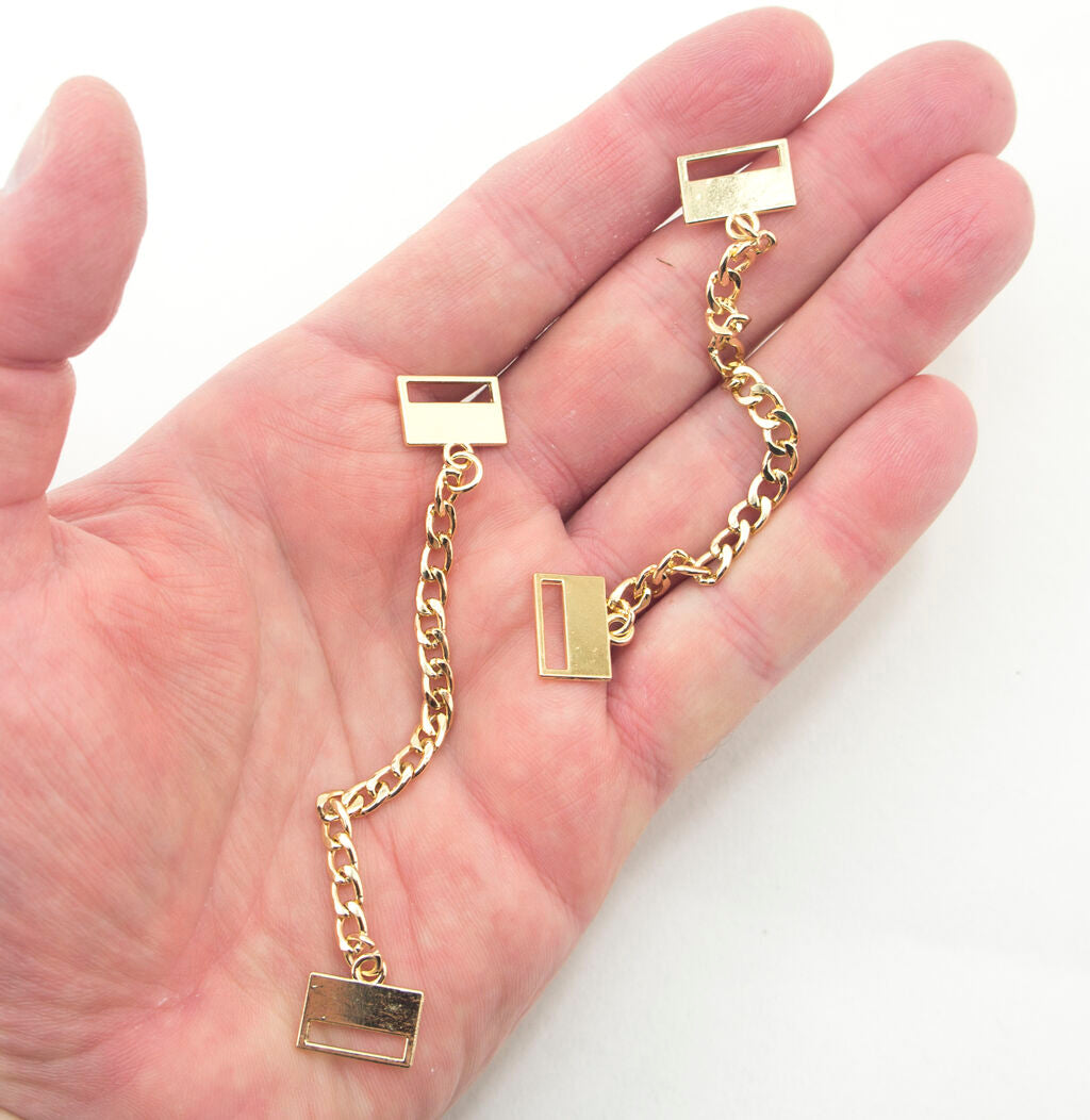 Close-up of the gold tone pendant chain showing details.