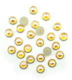 Pack of 25 gold tone circular embellishments with amber-rose crystals.