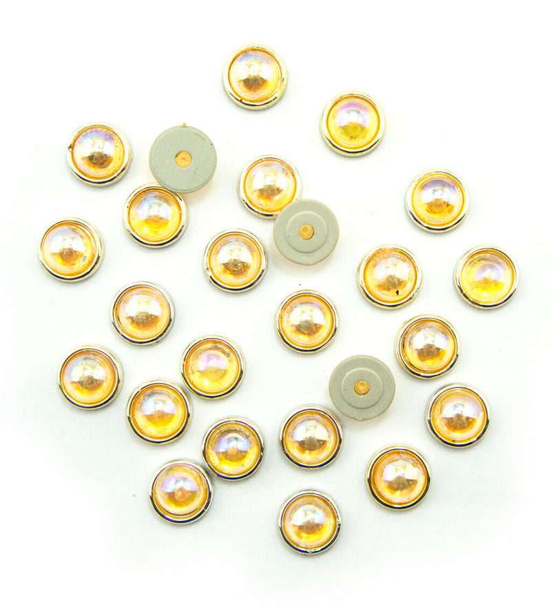 Pack of 25 gold tone circular embellishments with amber-rose crystals.