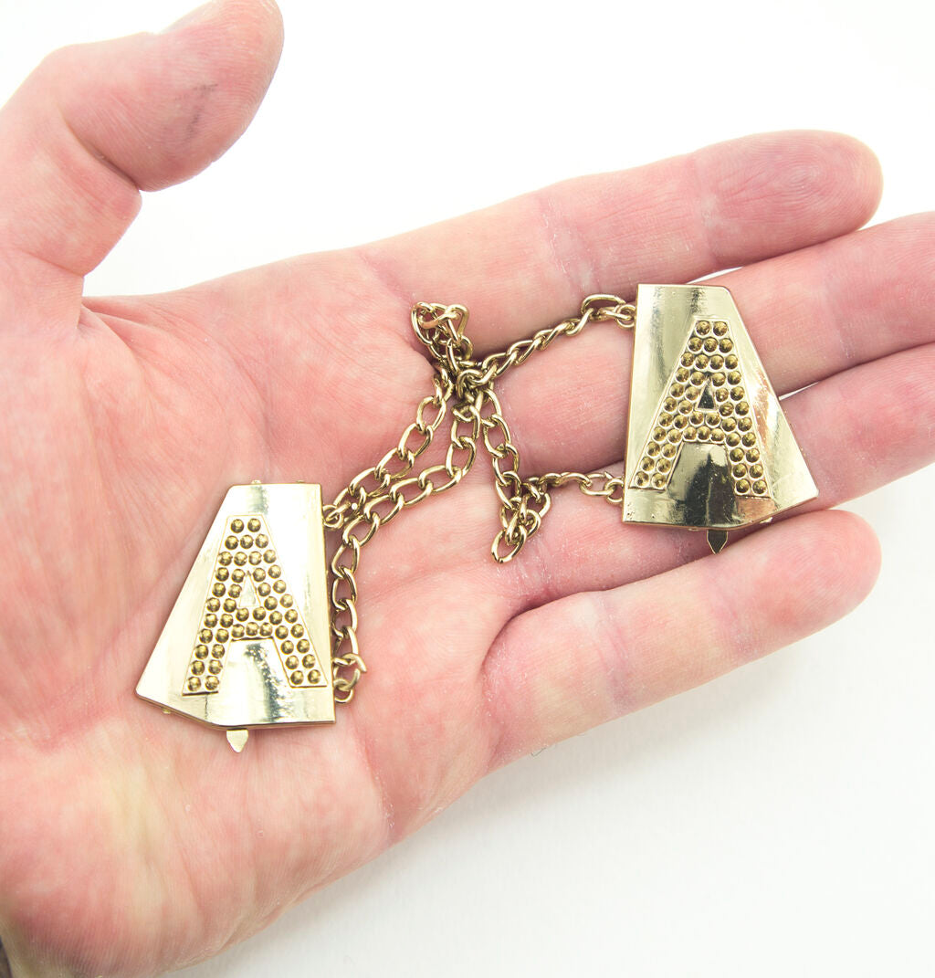 Close-up of gold tone Letter 'A' with back pins
