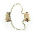 Gold tone metal Letter 'A' embellishment on fabric