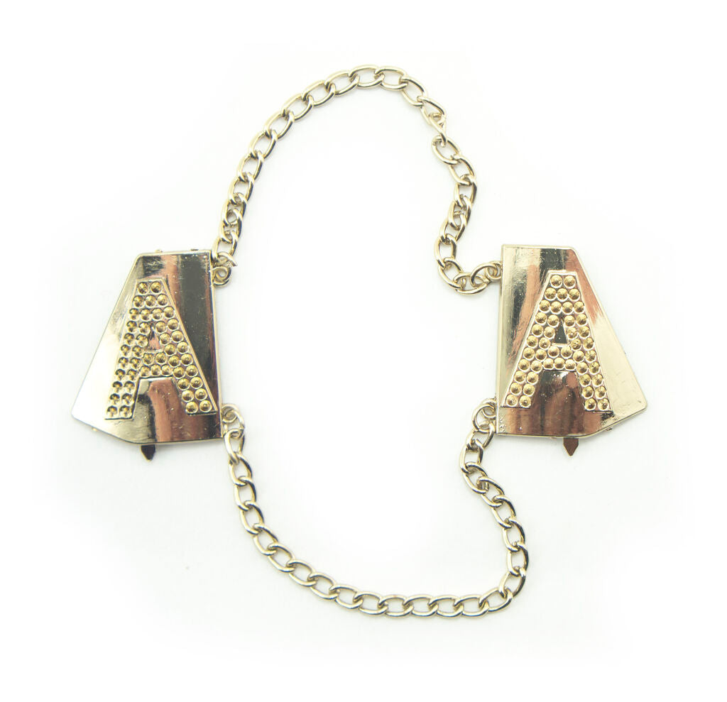 Gold tone metal Letter 'A' embellishment on fabric